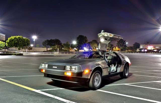 A DeLorean like the one used for time travel in Back to the Future sits in an empty parking lot