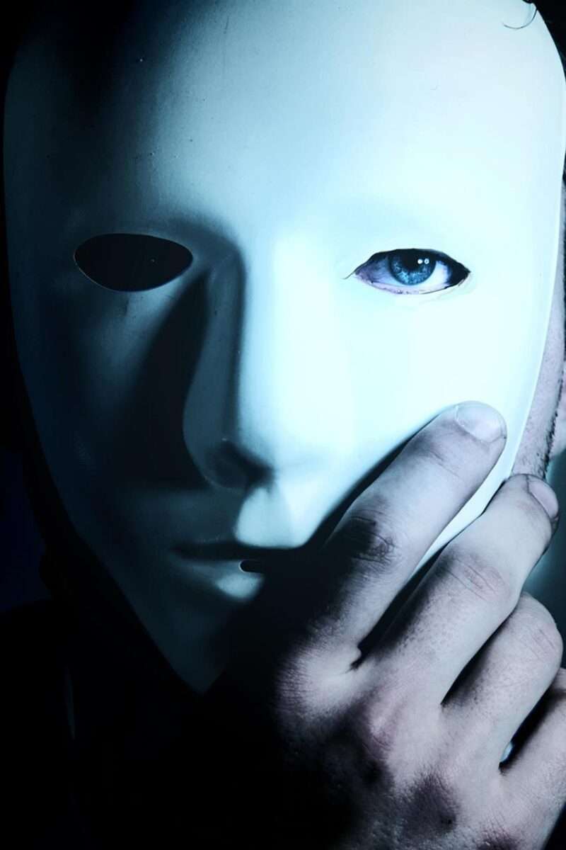 Photo of a man hiding behind a mask